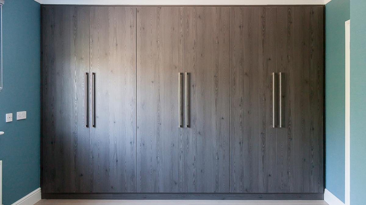 Modern grey built-in bedroom cupboards with long handles