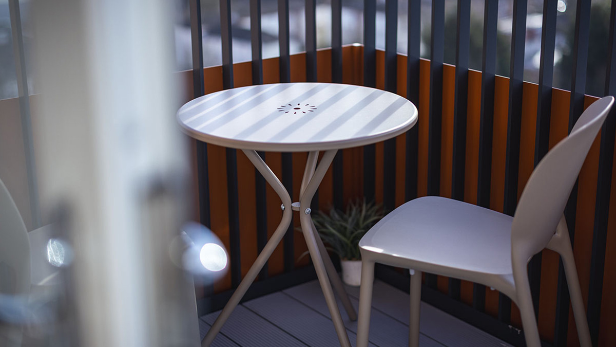 white outdoor table and chair on balcony at square roots