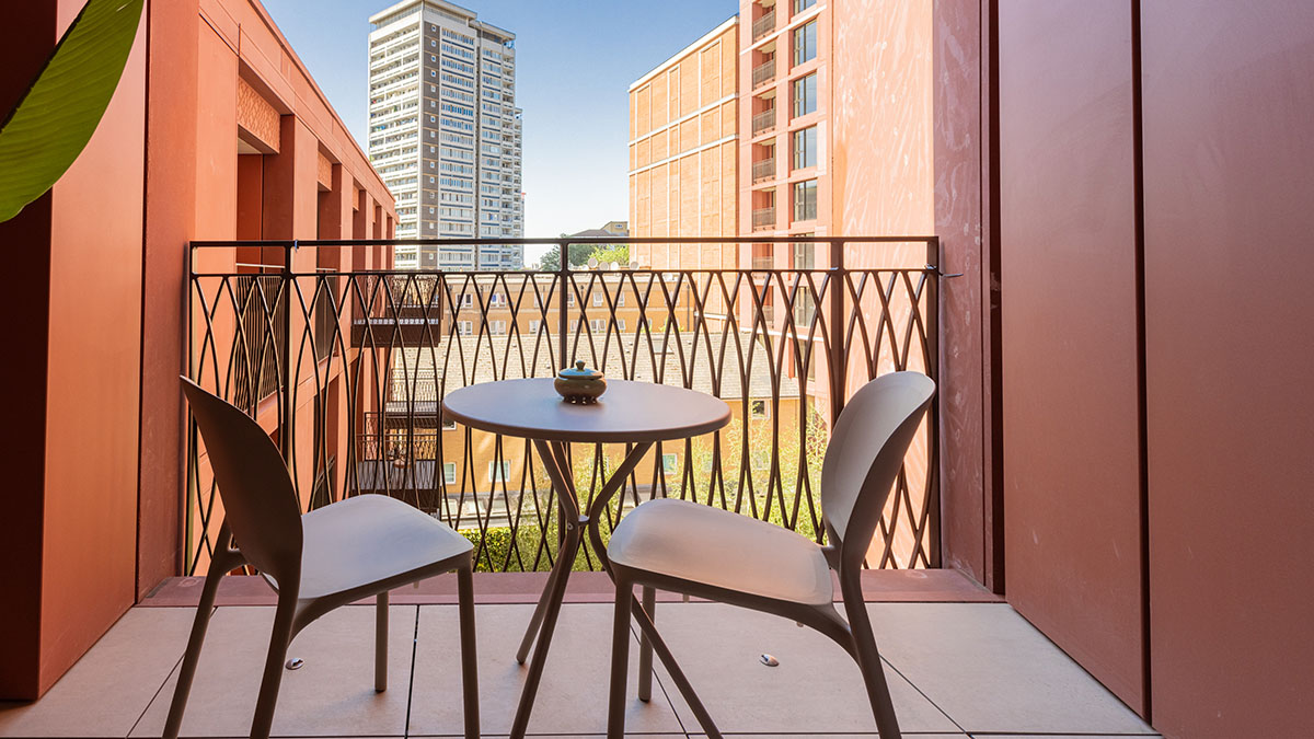 Modern balcony seating area at West End Gate apartment with city views in Paddington London